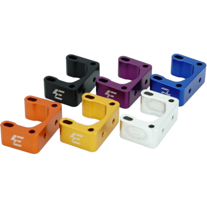 Six colorful metal handlebar risers in black, purple, blue, orange, gold, and silver.