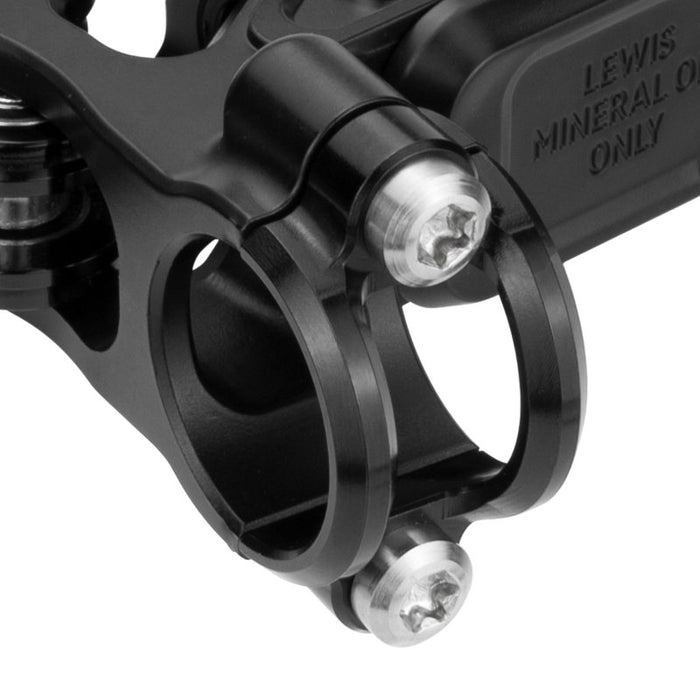 Black handlebar clamp close-up with bolts and textured brake fluid reservoir text