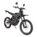 Black electric dirt bike with off-road tires and skid plate, side view