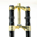 Gold and black motorcycle suspension fork triple clamp with steering tube.