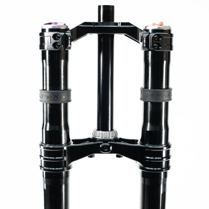 Black dual mountain bike suspension fork with clamps and adjustment knobs.