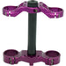 Purple anodized motorcycle triple tree clamp with black steering stem on white.