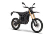 Black electric dirt bike with knobby tires and gold front forks